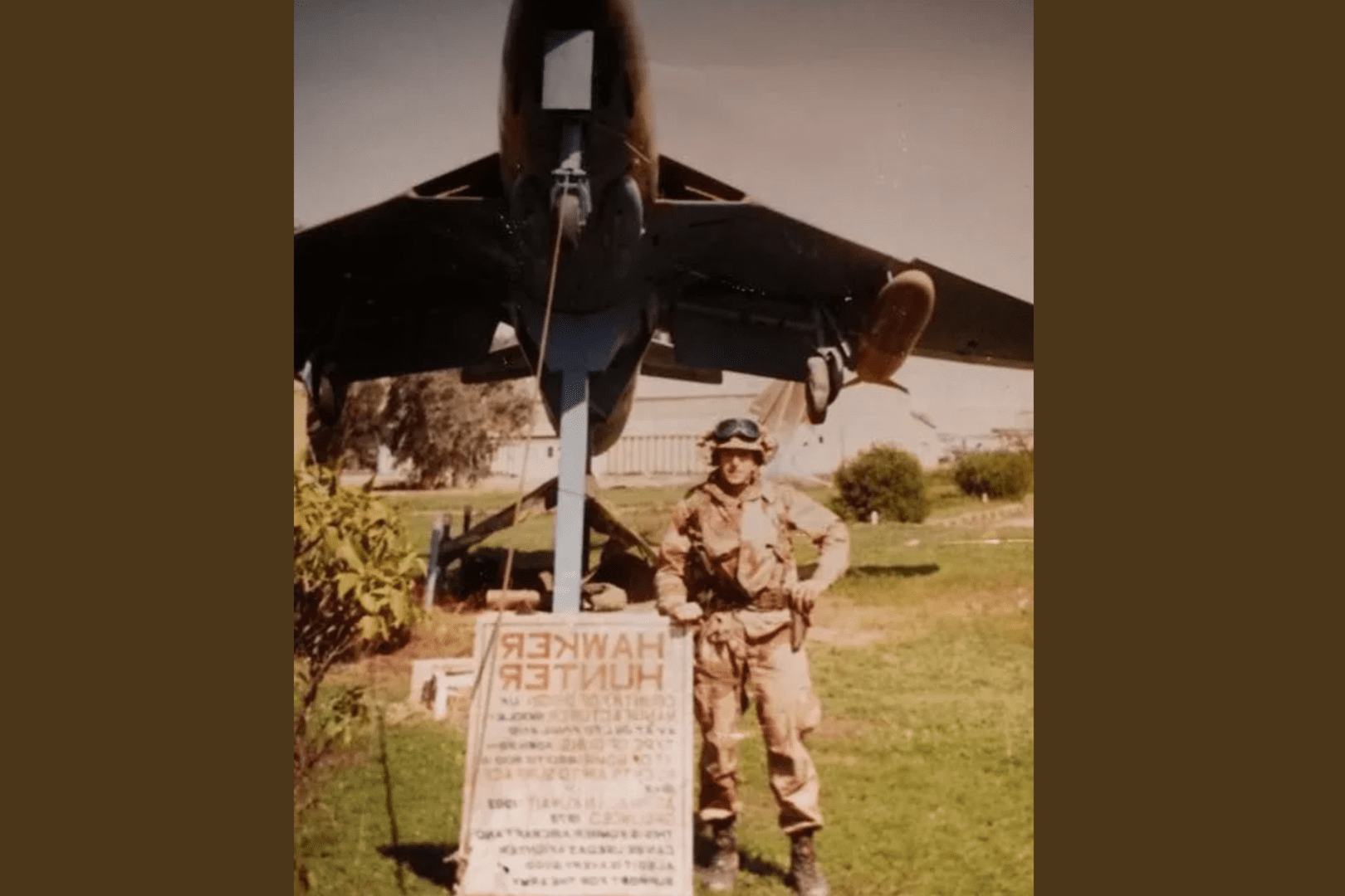 A man in uniform standing next to an airplane.